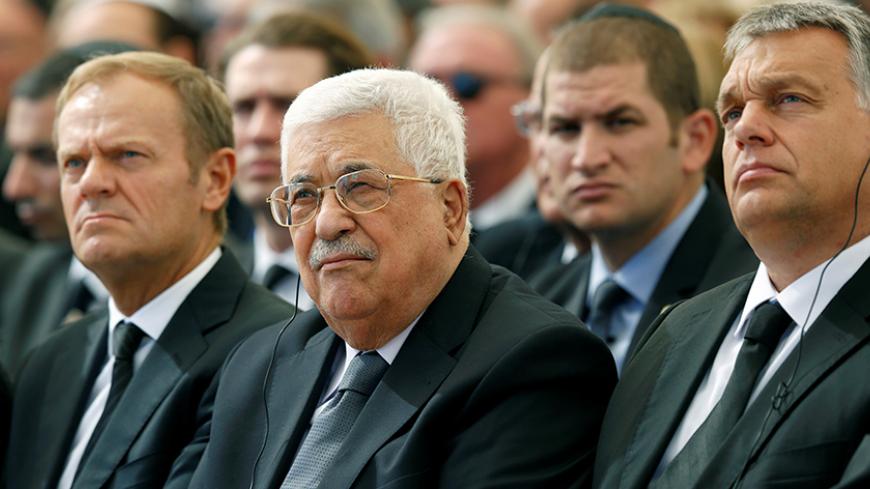 Palestinian President Mahmoud Abbas (C) sits alongside European Council President Donald Tusk (L) as they attend the funeral of Shimon Peres, 93, on Mount Herzl Cemetery in Jerusalem, September 30, 2016.  REUTERS/Abir Sultan/Pool - RTSQ58E