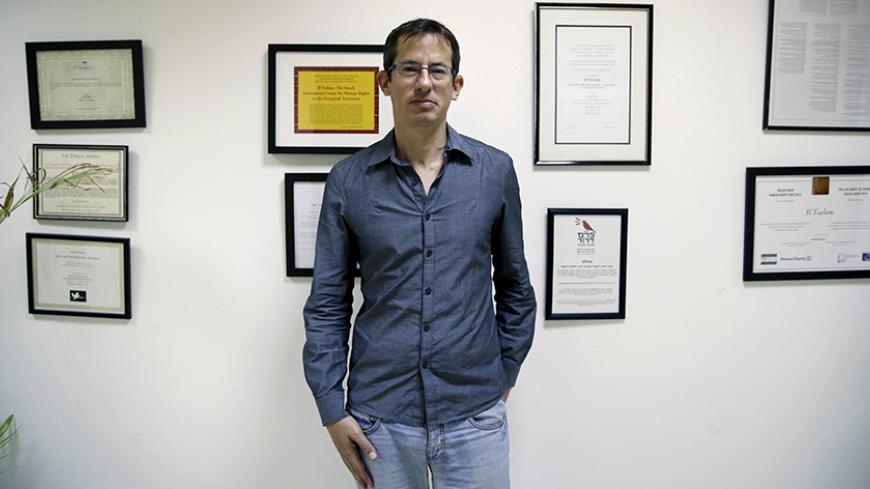 Hagai El-Ad, Executive Director of B'Tselem, a leading Israeli human rights organisation, poses in his office in Jerusalem December 16, 2015. An ultra-nationalist Israeli group has published a video accusing the heads of four of Israel's leading human rights organizations, including "B'Tselem", of being foreign agents funded by Europe and supporting Palestinians "involved in terrorism." REUTERS/Ammar Awad - RTX1YYPY