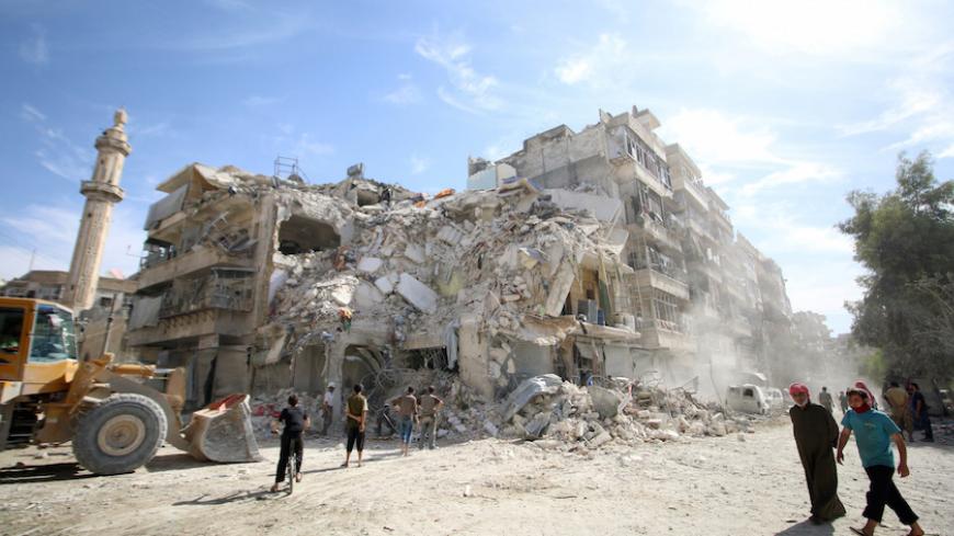 People inspect a damaged site after an air strike Sunday in the rebel-held besieged al-Qaterji neighbourhood of Aleppo, Syria October 17, 2016. REUTERS/Abdalrhman Ismail  - RTX2P5P3
