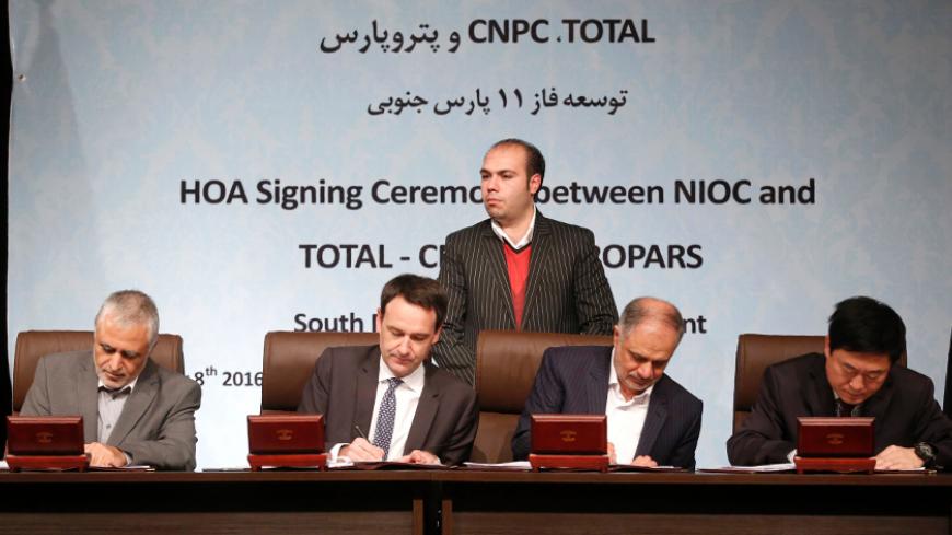 (L-R) Ali Kardor, Managing Director of the National Iranian Oil Company (NIOC), Stephane Michel, Total's head of Middle East exploration and production, Hamid Akbari, Managing Director of Petropars Group and Jean Ping Zhou, China National Petroleum Corporation (CNPC), sign an offshore gas field agreement in Tehran, on November 8, 2016.
Iran signed a deal with France's Total to develop a major offshore gas field, its first big contract with a Western energy firm since sanctions were loosened in January.

 / 