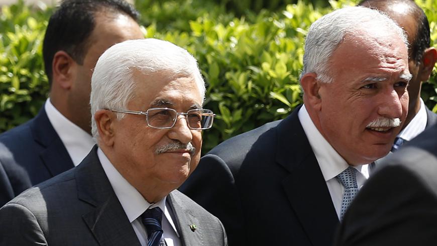 Palestinian President Mahmoud Abbas and  his foreign minister Riyad al-Maliki (R) arrive for an Arab League Foreign Ministers emergency meeting at the league's headquarters in Cairo September 7, 2014. Arab foreign ministers meeting in Cairo on Sunday are expected to issue a resolution backing Iraqi efforts to confront militants who have overrun large areas of Iraq and Syria and declared a cross-border Islamic caliphate, diplomats said.  REUTERS/Mohamed Abd El Ghany (EGYPT - Tags: POLITICS) - RTR458TQ