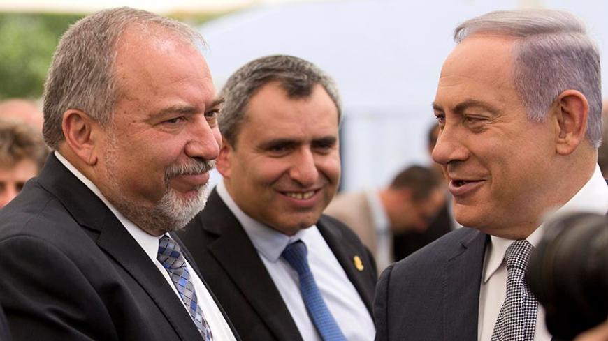 Israeli Prime Minister Benjamin Netanyahu (R) and Israel's defense minister, Avigdor Lieberman (L) during a special Cabinet meeting to mark Jerusalem Day in 1Ein Lavan Spring located in the outskirts of Jerusalem 02 June 2016. REUTERS/Abir Sultan/Pool - RTX2FADW