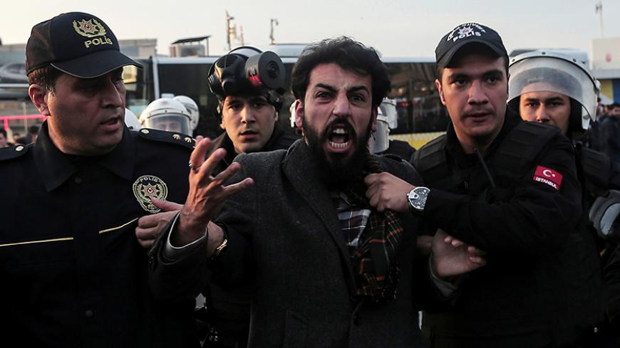 Police officers detain a protester during a protest against the arrest of pro-Kurdish Peoples' Democratic Party (HDP) lawmakers, in Istanbul, Turkey November 6, 2016. REUTERS/Huseyin Aldemir - RTX2S6QZ