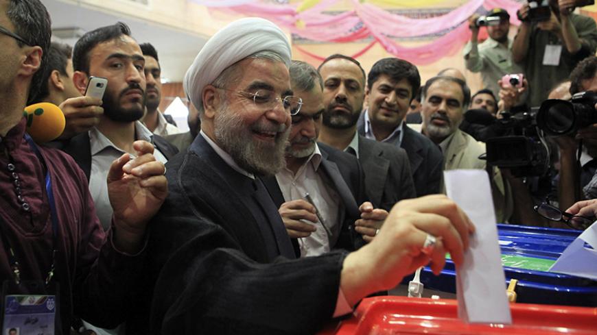 Presidential candidate Hassan Rouhani casts his ballot during the Iranian presidential election in Tehran June 14, 2013. Millions of Iranians voted to choose a new president on Friday, urged by Supreme Leader Ayatollah Ali Khamenei to turn out in force to discredit suggestions by arch foe the United States that the election would be unfair. REUTERS/Yalda Moayeri (IRAN - Tags: POLITICS ELECTIONS) - RTX10ND9
