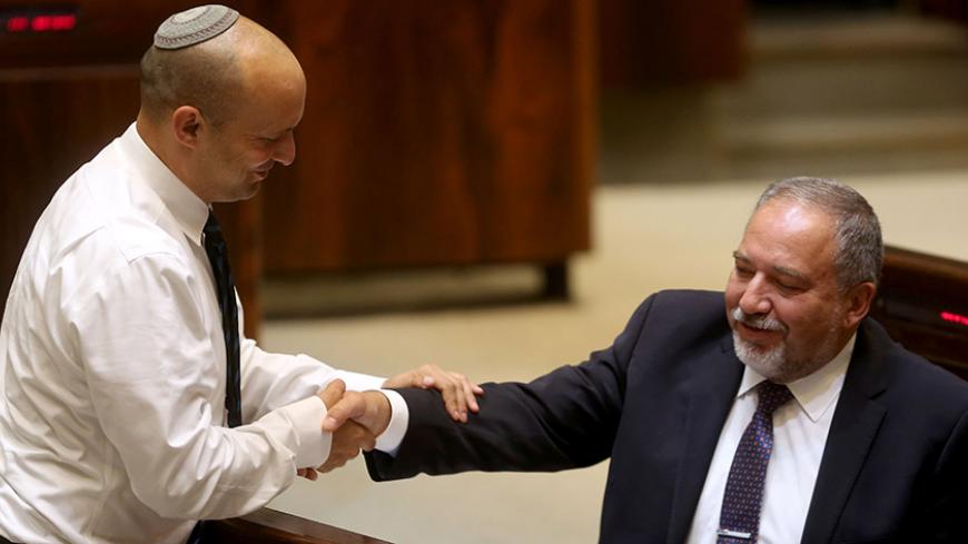 Israeli Jewish Home party leader Naftali Bennett (L) greets former Israeli foreign minister and ultra-nationalist MP Avigdor Lieberman during a session of the Israeli parliament in which MPs are debating whether to approve Lieberman's appointment as defence minister, on May 30, 2016 in Jerusalem.
Israeli Prime Minister Benjamin Netanyahu's cabinet voted to expand his coalition and appoint hardliner Avigdor Lieberman as defence minister, bringing weeks of political intrigue -- and outrage -- towards a close.
