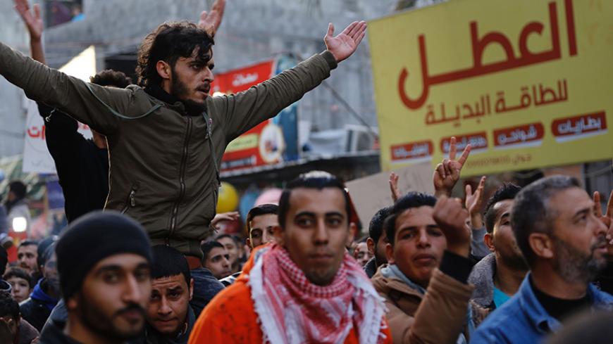 Palestinian activist Mohammed al-Taluli (top), 25, chants slogans during a protest at the Jabalia refugee camp in the northern Gaza Strip on January 12, 2017, against the Palestinian enclave's ongoing electricity crisis.
The 25-year-old nicknamed Guevara because of his admiration of the Latin American revolutionary has returned to his home despite warnings that Hamas security forces were looking for him due to his role as an organiser of recent protests over severe electricity shortages.
 / AFP / Mohammed A
