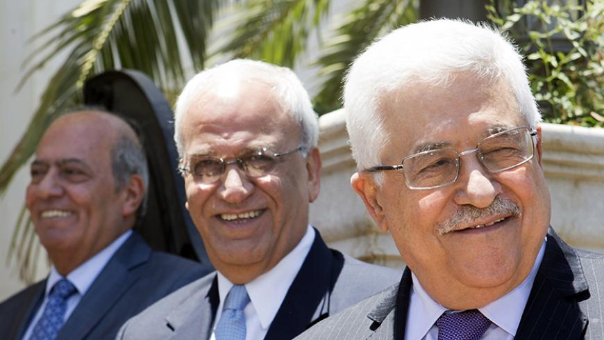 Palestinian President Mahmoud Abbas, with Palestinian ambassador to Jordan, Atallah Khairy (L), and Palestinian negotiator Saeb Erekat (C), says goodbye to U.S. Secretary of State John Kerry (not pictured) after their meeting in Amman June 29, 2013. Kerry extended his Middle East peace mission on Saturday, shuttling between Jerusalem and Amman for more talks with Israeli and Palestinian leaders on reviving their stalled negotiations. REUTERS/Jacquelyn Martin/Pool (JORDAN - Tags: POLITICS) - RTX116CH