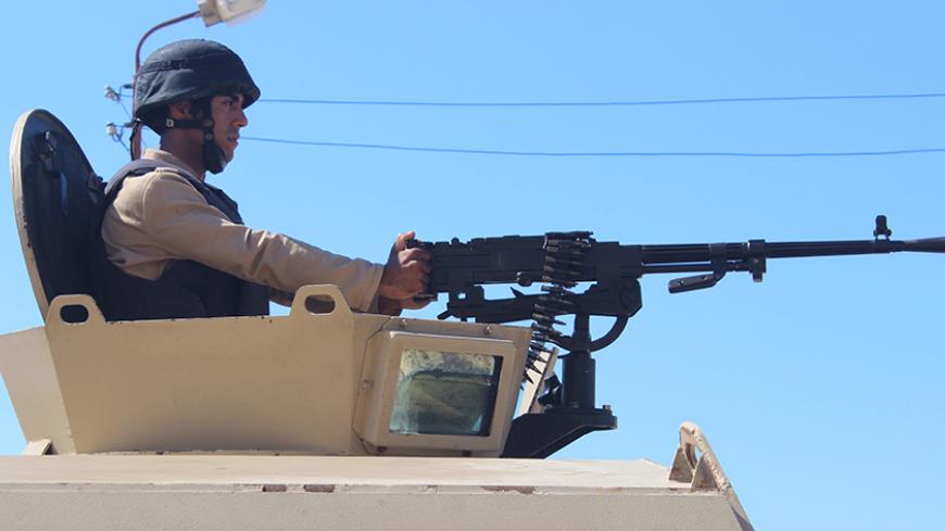 An Egyptian army soldier looks on from his postion at a checkpoint in Al Arish city, in the troubled northern part of the Sinai peninsula, July 8, 2015. Giant posters of Egyptian President Abdel Fattah al-Sisi in military uniform hang at security checkpoints leading to the Sinai, but the crash of a Russian airliner in the peninsula has shattered the image of control they seek to project. Picture taken July 8, 2015.       To match EGYPT-CRASH/INSURGENCY-INSIGHT       REUTERS/Stringer - RTX1V321