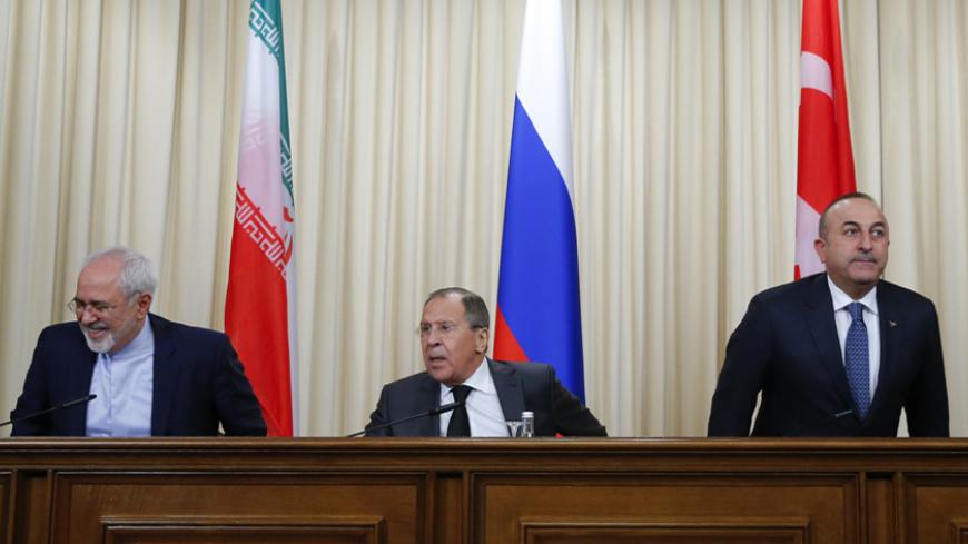 Foreign ministers, Sergei Lavrov (C) of Russia, Mevlut Cavusoglu (R) of Turkey and Mohammad Javad Zarif of Iran, attend a news conference in Moscow, Russia, December 20, 2016. REUTERS/Maxim Shemetov - RTX2VUYG