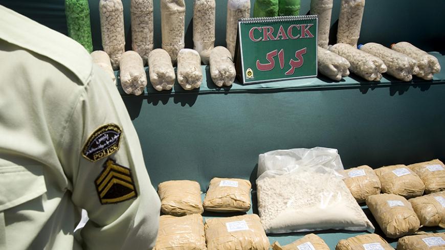An Iranian anti-narcotics policeman stands guard beside a display of confiscated drugs during a ceremony concluding anti-narcotics manoeuvres in Zahedan, 1,605 kilometers (1,003 miles) southeast of Tehran May 20, 2009.  The head of the U.N. crime agency praised Iran during a visit on Wednesday for curbing the flow of smuggled heroin from Afghanistan and helping keep the drug off Western streets.  Picture taken May 20, 2009. REUTERS/Caren Firouz (IRAN CRIME LAW POLITICS SOCIETY) - RTXKL1B