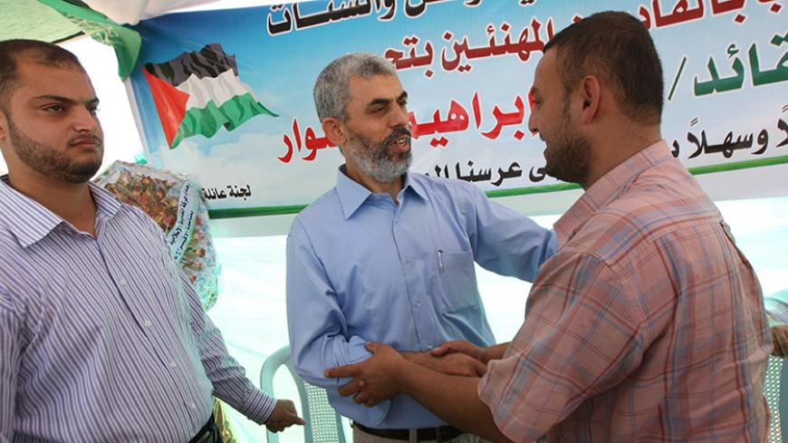 Freed Palestinian Hamas leader Yehia Sinwar (C) greets supporters following his release from an Israeli jail at a welcome tent near his home in Khan Yunis, southern Gaza Strip, on October 19, 2011. The Palestinian Hamas movement exchanged Gilad Shalit, the Israeli soldier who spent more than five years of isolation in a Gaza hide-out, for hundreds of Palestinian militants being held in Israeli jails. AFP PHOTO/SAID KHATIB (Photo credit should read SAID KHATIB/AFP/Getty Images)