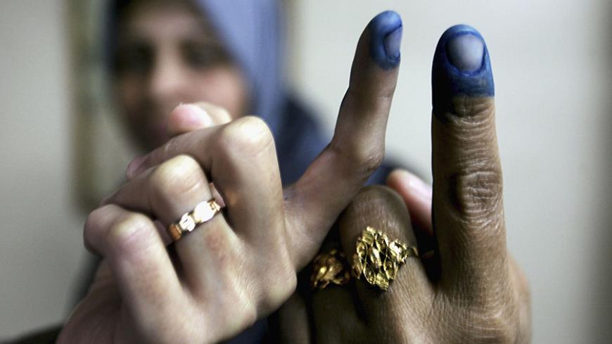 GAZA CITY, GAZA STRIP - JANUARY 25:  Palestinian women show their inked fingers after voting in the Palestinian legislative election at a UN school which is being used as a polling station, January 25, 2006, in Gaza City, Gaza Strip. The newly elected Palestinian Legislative Council (PLC) will be expanded, and half of the seats will be allotted by proportional representation of all parties that gather more than two percent of the vote. (Photo by Abid Katib/Getty Images)