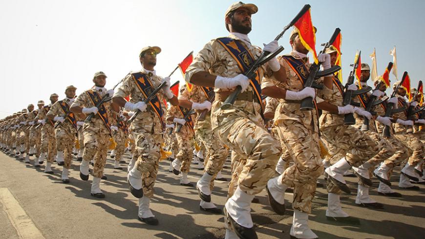Members of the Iranian revolutionary guard march during a parade to commemorate the anniversary of the Iran-Iraq war (1980-88), in Tehran September 22, 2011. REUTERS/Stringer/File Photo - RTX2O269