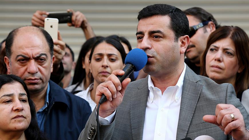 Selahattin Demirtas, co-leader of the pro-Kurdish Peoples' Democratic Party (HDP), talks during a gathering to protest against the arrest of the city's two joint mayors on terrorism charges, in the southeastern city of Diyarbakir, Turkey, October 30, 2016. REUTERS/Sertac Kayar - RTX2R1KM