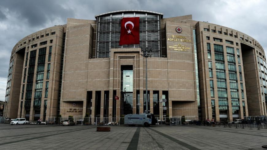 A photo taken on July 20, 2016 shows a Turkish flag on the Istanbul Justice Palace (Adalet Sarayi).
Turkish President Recep Tayyip Erdogan on July 20 chaired a crunch security meeting for the first time since the failed coup, as global alarm grew over a widening purge that has seen around 50,000 people either detained or sacked. / AFP / BULENT KILIC        (Photo credit should read BULENT KILIC/AFP/Getty Images)