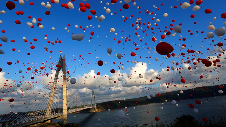 Red and white balloons are released during the opening ceremony of newly built Yavuz Sultan Selim bridge, the third bridge over the Bosphorus linking the city's European and Asian sides in Istanbul, Turkey, August 26, 2016. REUTERS/Murad Sezer - RTX2N6ZG