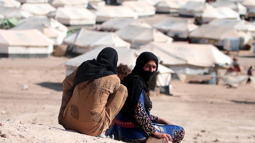 Iraqi refugee women sit overlooking al-Howl refugee camp south of Hasaka city, Syria October 20, 2016. REUTERS/Rodi Said - RTX2PS92
