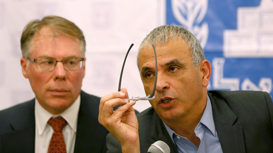 Israel's Finance Minister Moshe Kahlon (R) speaks as Craig Beaumont of the International Monetary Fund (IMF) sits next to him, during a news conference to present an IMF report in Jerusalem, Israel February 8, 2017. REUTERS/Ronen Zvulun - RTX306CP
