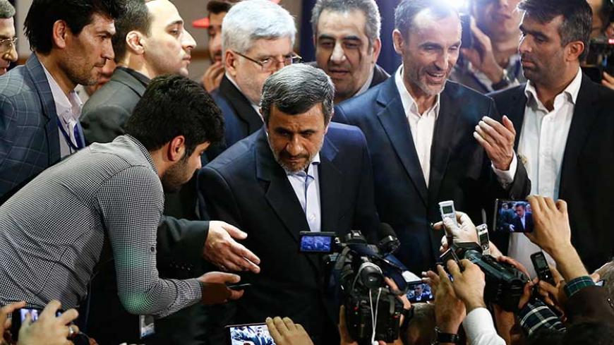 Former Iranian president Mahmoud Ahmadinejad (C) stands with former Iranian Vice President Hamid Baghaei (R) after registering at the Interior Ministry's election headquarters as candidates begin to sign up for the upcoming presidential elections in Tehran on April 12, 2017.
Ahmadinejad had previously said he would not stand after being advised not to by supreme leader Ayatollah Ali Khamenei, saying he would instead support his former deputy Hamid Baghaie who also registered on Wednesday. / AFP PHOTO / ATTA