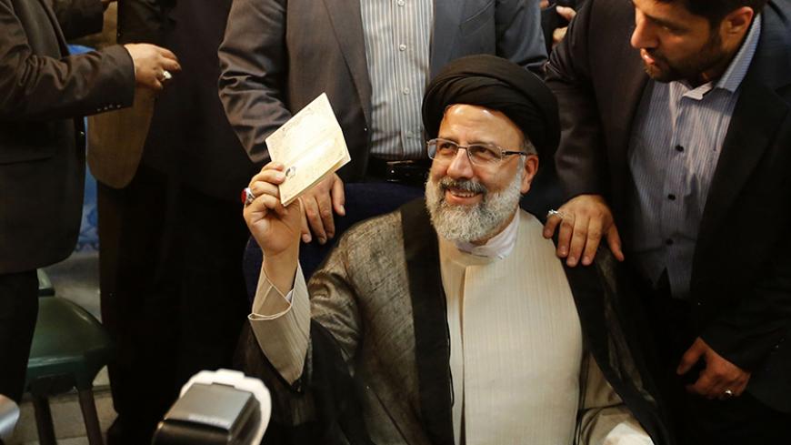 Iranian cleric and head of the Imam Reza charitable foundation, Ebrahim Raisi, gestures after registering his candidacy for the upcoming presidential elections at the ministry of interior in the capital Tehran on April 14, 2017. / AFP PHOTO / ATTA KENARE        (Photo credit should read ATTA KENARE/AFP/Getty Images)