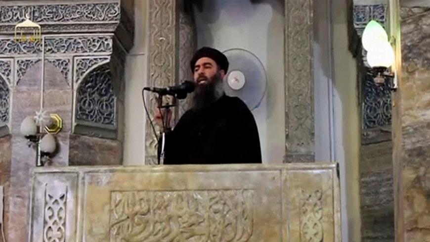 FILE PHOTO: A man purported to be the reclusive leader of the militant Islamic State Abu Bakr al-Baghdadi making what would have been his first public appearance, at a mosque in the centre of Iraq's second city, Mosul, according to a video recording posted on the Internet on July 5, 2014, in this still image taken from video.    REUTERS/Social Media Website via Reuters TV/File Photo  ATTENTION EDITORS - THIS IMAGE HAS BEEN SUPPLIED BY A THIRD PARTY. IT IS DISTRIBUTED, EXACTLY AS RECEIVED BY REUTERS, AS A SE