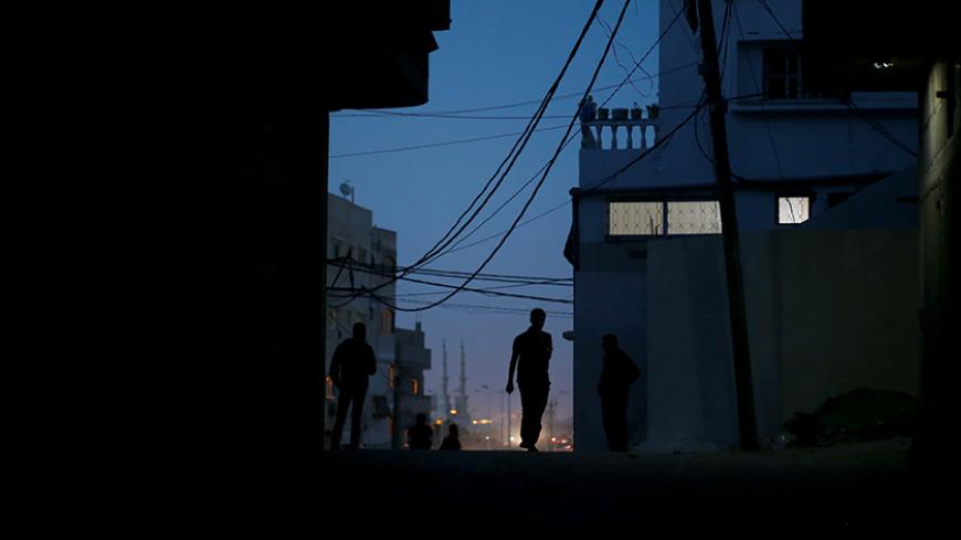 A Palestinian man walks during power cut at Shati refugee camp in Gaza City April 25, 2017. Picture taken April 25, 2017. REUTERS/Mohammed Salem - RTS14596