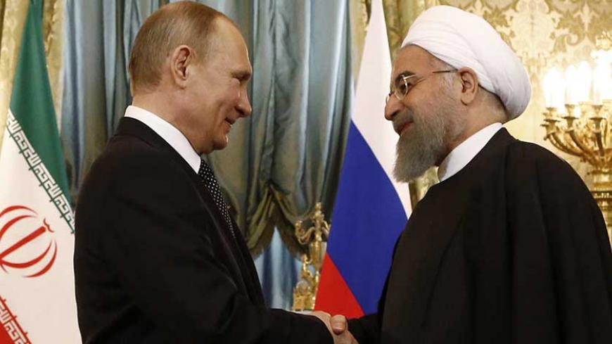 Russian President Vladimir Putin shakes hands with Iranian President Hassan Rouhani during their meeting at the Kremlin in Moscow, Russia March 28, 2017. REUTERS/Sergei Karpukhin - RTX331H1