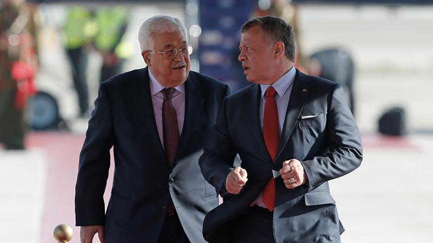 Jordan's King Abdullah II welcomes Palestinian President Mahmoud Abbas (L) during a reception ceremony at the Queen Alia International Airport in Amman, Jordan March 28, 2017. REUTERS/Muhammad Hamed - RTX336DK