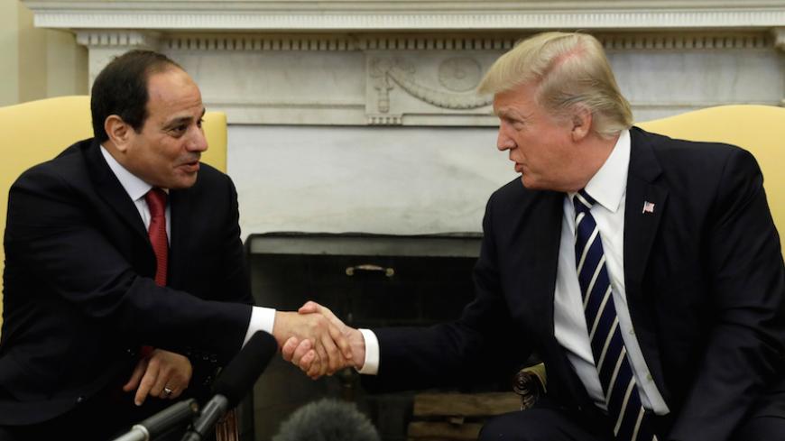 U.S. President Donald Trump shakes hands with Egyptian President Abdel Fattah al-Sisi in the Oval Office of the White House in Washington, U.S., April 3, 2017. REUTERS/Kevin Lamarque - RTX33W8K
