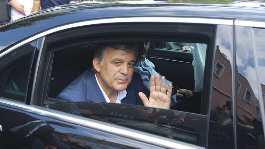 Former Turkish President Abdullah Gul waves from a car as he leaves a memorial service for the victims of the thwarted coup in Istanbul, Turkey, July 17, 2016.       REUTERS/Kemal Aslan - RTSIDEV