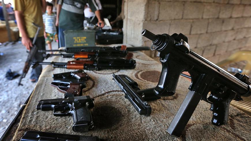 Machine guns are on display at an arms market in Arbil, the capital of the autonomous Kurdish region of northern Iraq on August 17, 2014. Iraqi Kurdish peshmerga forces backed by US air strikes retook the country's largest dam from jihadist militants who seized it the previous week, officials said. AFP PHOTO/SAFIN HAMED        (Photo credit should read SAFIN HAMED/AFP/Getty Images)