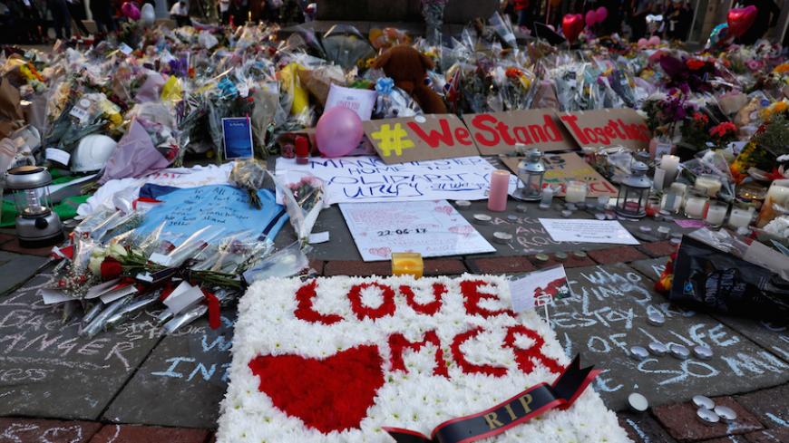 Flowers and messages of condolence are left for the victims of the Manchester Arena attack, in central Manchester, Britain May 25, 2017. REUTERS/Stefan Wermuth - RTX37J8V