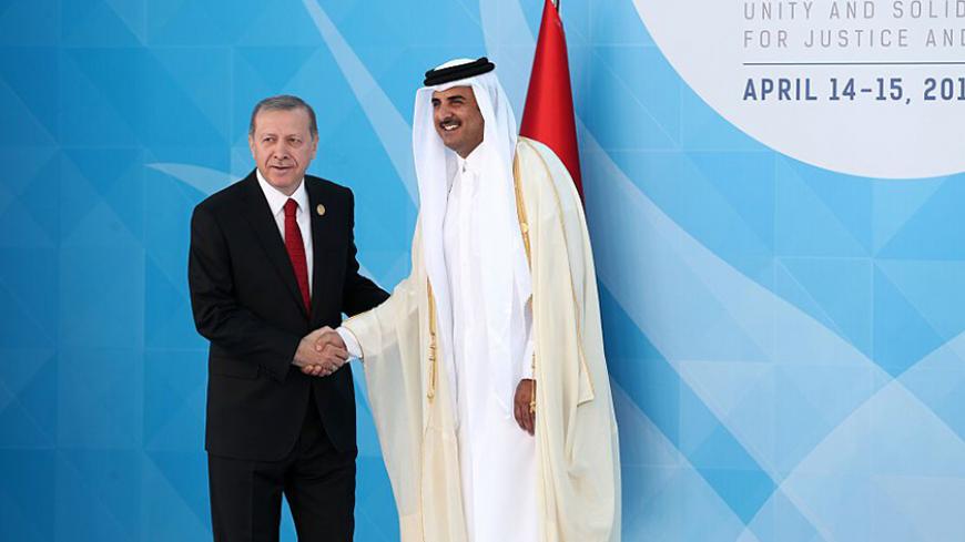 Turkish President Recep Tayyip Erdogan (L) shakes hands with Emir of Qatar, Sheikh Tamim bin Hamad Al Thani (R) during the 13th Organization of Islamic Cooperation (OIC) Summit at Istanbul Congress Center (ICC) on April 14, 2016 in Istanbul. 
Erdogan on April 14 hosts over 30 heads of state and government from Islamic countries in Istanbul for a major summit aimed at overcoming differences in the Muslim world.  / AFP / POOL / ARIF HUDAVERDI YAMAN        (Photo credit should read ARIF HUDAVERDI YAMAN/AFP/Get