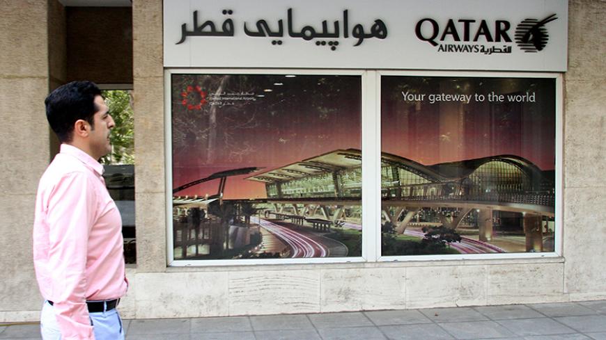 An Iranian man walks past a Qatar Airways branch in the capital Tehran on June 6, 2017.
A ban on Qatari flights imposed by Saudi Arabia and its allies took effect as first efforts were made to resolve the biggest feud to hit the Arab world in years. Saudi Arabia and allies including Egypt, the United Arab Emirates and Bahrain cut diplomatic ties and transport links with Qatar on Monday, accusing the Gulf state of supporting extremism.
 / AFP PHOTO / ATTA KENARE        (Photo credit should read ATTA KENARE/A