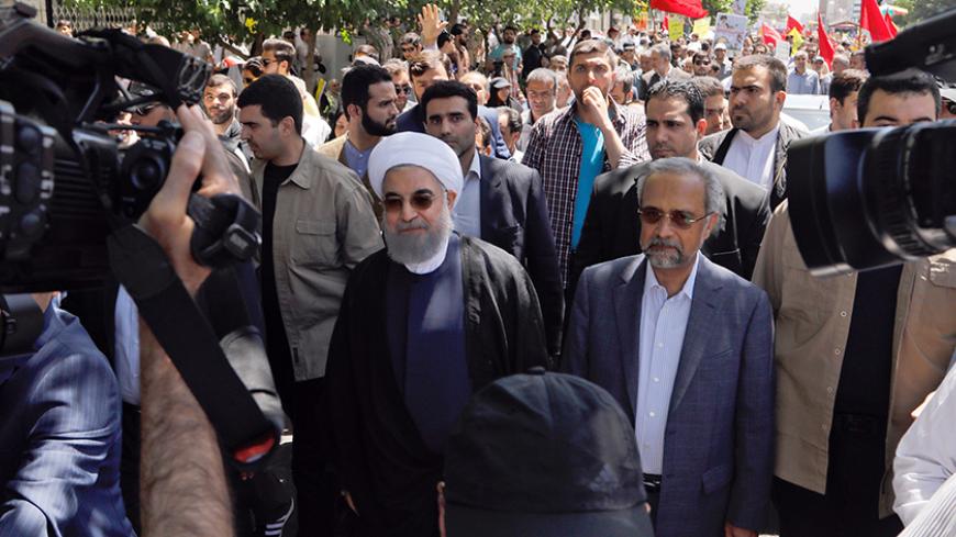 Iranian president Hassan Rouhani takes part in a rally marking al-Quds (Jerusalem) Day in Tehran on June 23, 2017. 
Chants against the Saudi royal family and the Islamic State group mingled with the traditional cries of "Death to Israel" and "Death to America" at Jerusalem Day rallies across Iran today.
 / AFP PHOTO / Stringer        (Photo credit should read STRINGER/AFP/Getty Images)