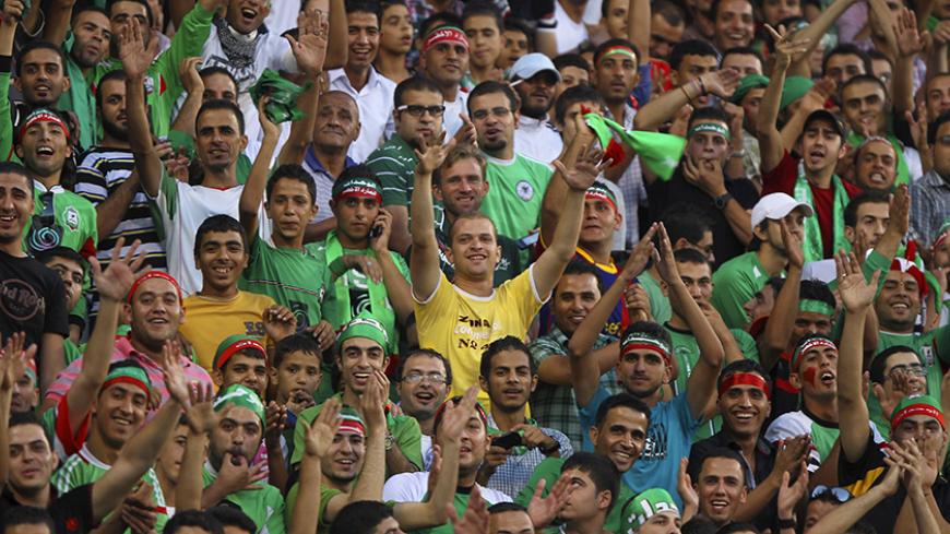 Jordan's Al-Wehdat fans cheer for their team playing against Kuwait's Al Kuwait during their AFC Cup soccer match at King Abdullah Stadium in Amman September 25, 2012. REUTERS/Muhammad Hamed (JORDAN - Tags: SPORT SOCCER) - RTR38ESJ
