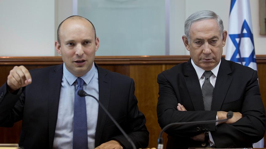 Israeli Prime Minister Benjamin Netanyahu (R) sits next to Education Minister Naftali Bennett during the weekly cabinet meeting at his office in Jerusalem, 30 August  2016. REUTERS/Abir Sultan/Pool - RTX2NKGO