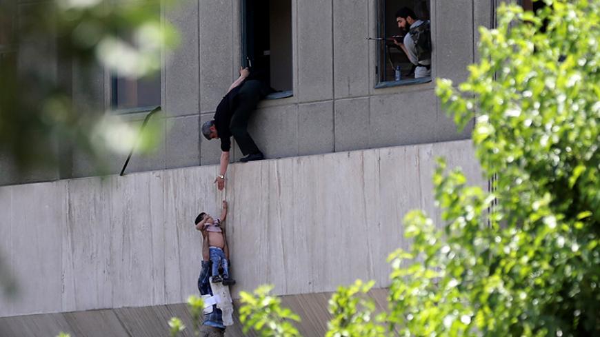 A boy is evacuated during an attack on the Iranian parliament in central Tehran, Iran, June 7, 2017. Omid Vahabzadeh/TIMA via REUTERS ATTENTION EDITORS - THIS IMAGE WAS PROVIDED BY A THIRD PARTY. FOR EDITORIAL USE ONLY.   THIS PICTURE WAS PROCESSED BY REUTERS TO ENHANCE QUALITY. AN UNPROCESSED VERSION HAS BEEN PROVIDED SEPARATELY.     TPX IMAGES OF THE DAY - RTX39ENI