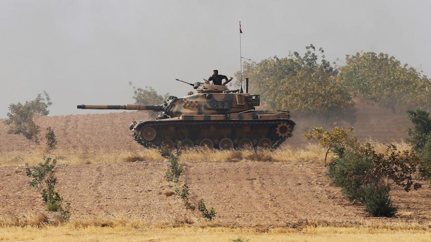 A Turkish army tank drives towards to the border in Karkamis on the Turkish-Syrian border in the southeastern Gaziantep province, Turkey, August 25, 2016. REUTERS/Umit Bektas - RTX2MYWT