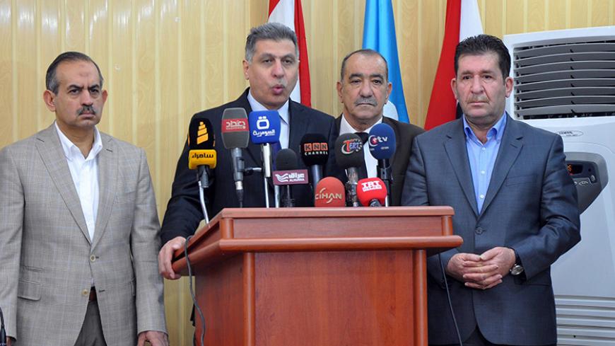 Chairman of the Iraqi Turkmen Front (ITC) Arshad al-Salihi (2nd-L) speaks during a press conference in the ethnically mixed northern Iraqi city of Kirkuk on June 28, 2014, to denounce comments made by Iraqi Kurdish leader Massud Barzani about the city. Barzani said Baghdad could no longer object to Kurdish self-rule in Kirkuk and other areas from which federal forces withdrew as the insurgents advanced. AFP PHOTO/MARWAN IBRAHIM        (Photo credit should read MARWAN IBRAHIM/AFP/Getty Images)