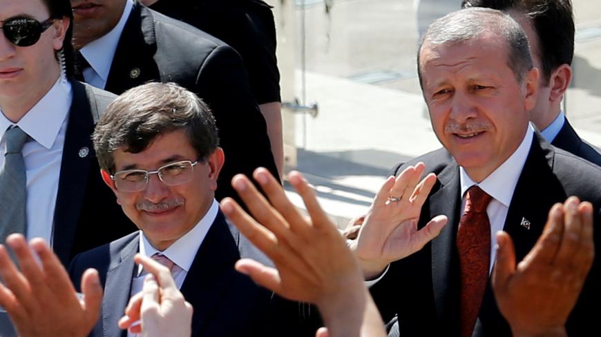 Turkey's then-Prime Minister Tayyip Erdogan (R) and then-Foreign Minister Ahmet Davutoglu greet their supporters as they leave Friday prayers in Ankara, Turkey, August 22, 2014. REUTERS/Umit Bektas/File Photo - D1AETCCKOAAA
