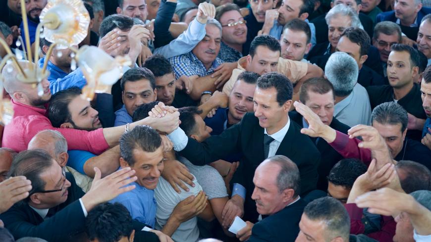 Syria's President Bashar al-Assad greets his supporters during Eid al-Adha prayers at a mosque in the town of Qara, north of Damascus, in this handout picture provided by SANA on September 1, 2017, Syria. SANA/Handout via REUTERS ATTENTION EDITORS - THIS IMAGE WAS PROVIDED BY A THIRD PARTY. REUTERS IS UNABLE TO INDEPENDENTLY VERIFY THIS IMAGE. - RC1EA1EC0D40