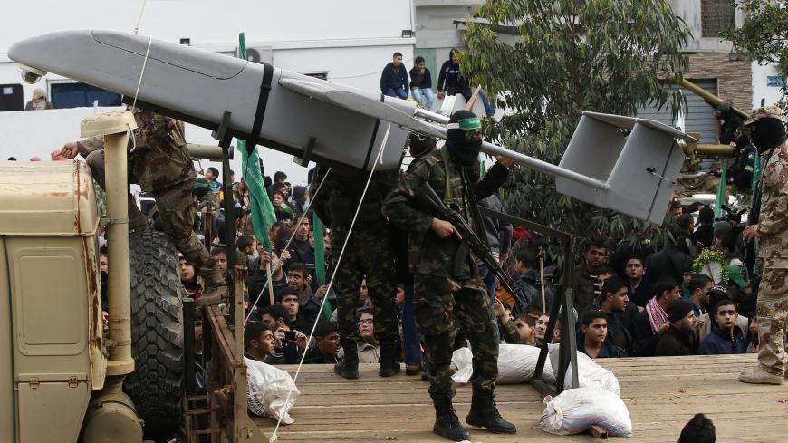Palestinian members of al-Qassam Brigades, the armed wing of the Hamas movement, display a home-made drone during a military parade marking the 27th anniversary of Hamas' founding, in Gaza City December 14, 2014.   REUTERS/Mohammed Salem (GAZA - Tags: POLITICS MILITARY ANNIVERSARY) - GM1EACE1NTL01