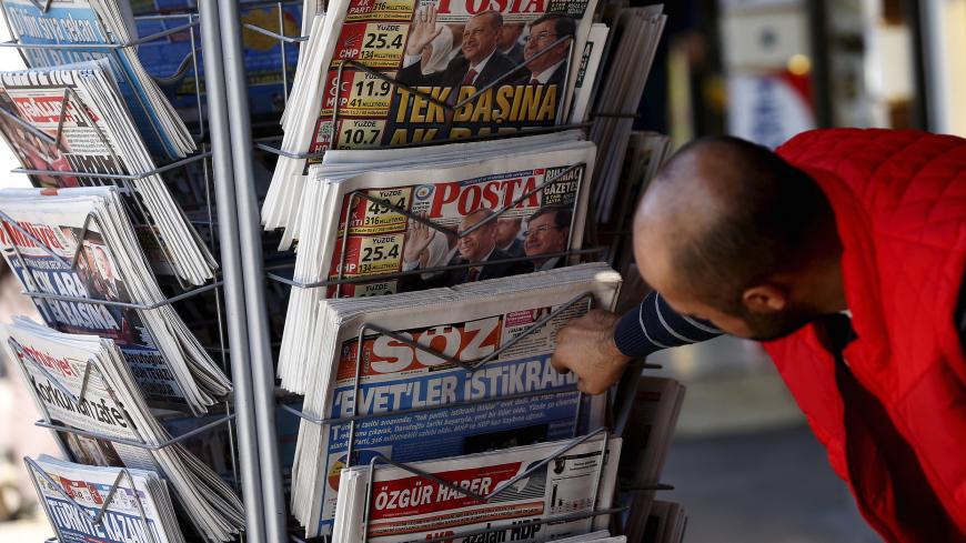 A man looks at newspapers at a kiosk in Diyarbakir, Turkey November 2, 2015. Turkish President Tayyip Erdogan said on Monday the nation had voted for stability in a parliamentary election that saw the AK Party he founded win almost 50 percent of the vote, and said the world should respect the result.  REUTERS/Stoyan Nenov - GF20000042856