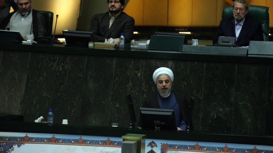 Iranian President Hassan Rouhani (bottom) delivers a speech to parliament before presenting the proposed annual budget in Tehran on December 7, 2014. Iran's parliament has adopted a law on December 4, to tax religious foundations and military-linked companies, a first for the Islamic republic that could generate hundreds of millions of dollars in revenues, media reported. AFP PHOTO/ATTA KENARE        (Photo credit should read ATTA KENARE/AFP/Getty Images)