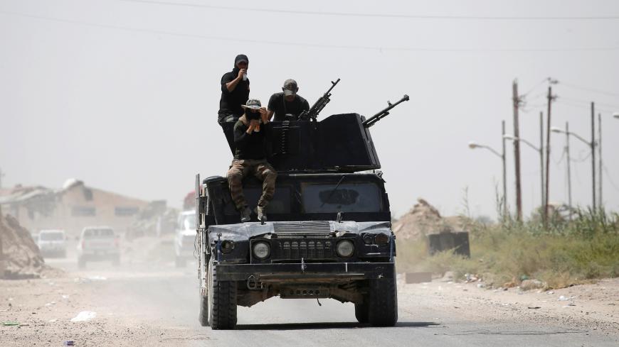 Iraqi counterterrorism forces sit in a top of a military vehicle in Falluja, Iraq, June 23, 2016. REUTERS/Thaier Al-Sudani - S1AETLOGUBAB