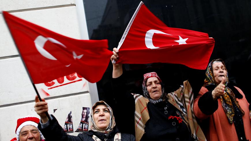 Demonstrators wave Turkish flags during a protest in front of the Dutch Consulate in Istanbul, Turkey, March 12, 2017. REUTERS/Murad Sezer - RC1DBCCB3850