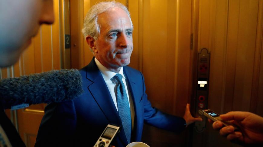 U.S. Senator Bob Corker (R-TN) speaks with reporters as he walks from the Senate floor between votes on procedural measures leading up to potential tax overhaul legislation at the U.S. Capitol in Washington, U.S., December 1, 2017. REUTERS/Jonathan Ernst - RC1657C8AC00