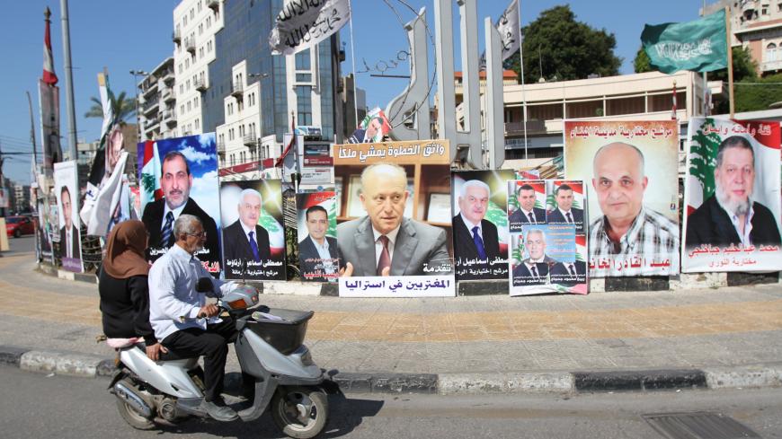 A poster depicting Sunni politician Ashraf Rifi (C) is seen among posters of Lebanese candidates that were running in Tripoli's municipal and mayoral elections, Lebanon, May 30, 2016. REUTERS/Omar Ibrahim - S1BETHAZUQAA