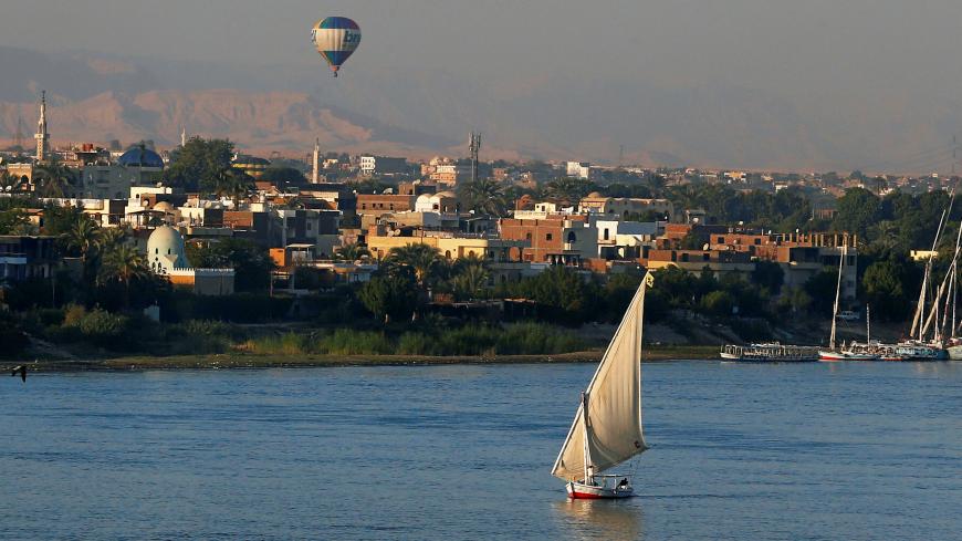 A balloon is seen above the Nile River as boats wait for tourists in the port city of Luxor, south of Cairo, Egypt December 14, 2016. Picture taken December 14, 2016. REUTERS/Amr Abdallah Dalsh - RC155D167990